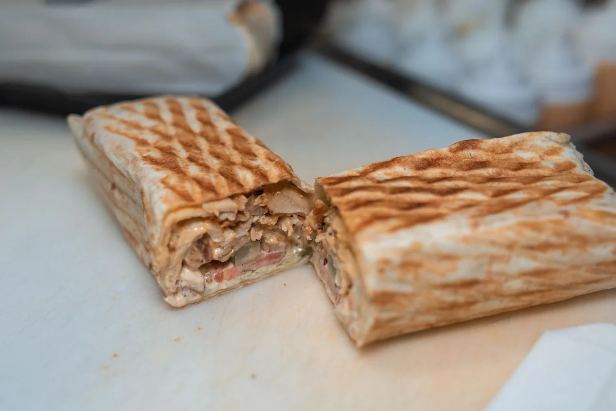 Chicken shawarma wrap sliced in half